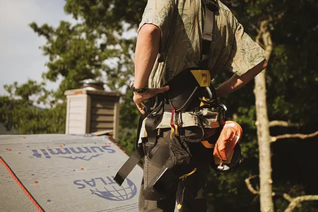Crew member in harness on underlayment